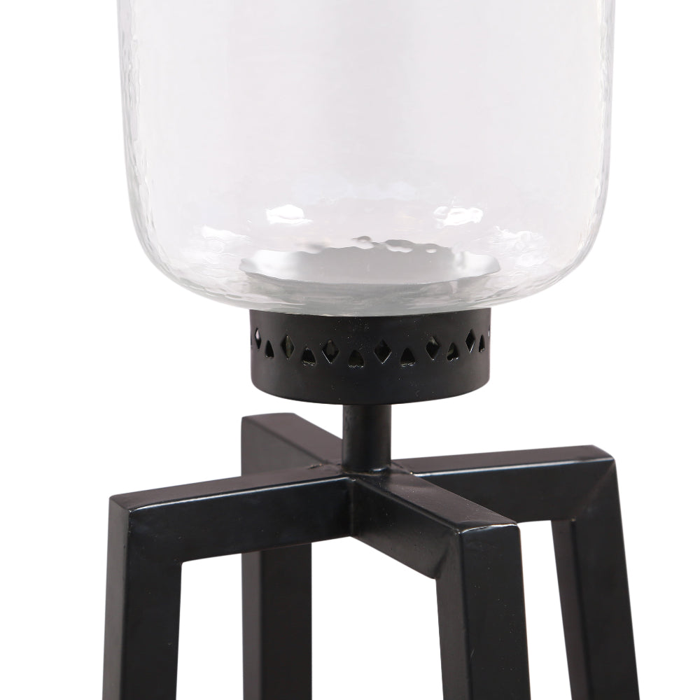Black metal and glass candle holder on a white background