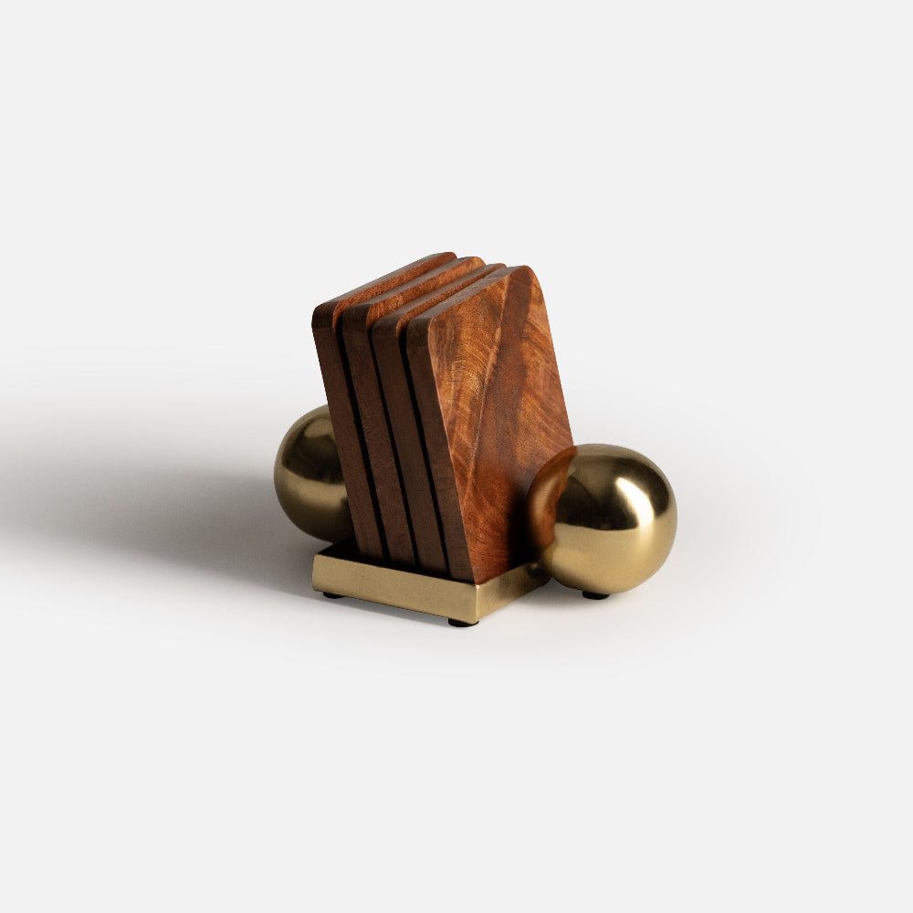 Wooden block with gold spherical elements on a white background