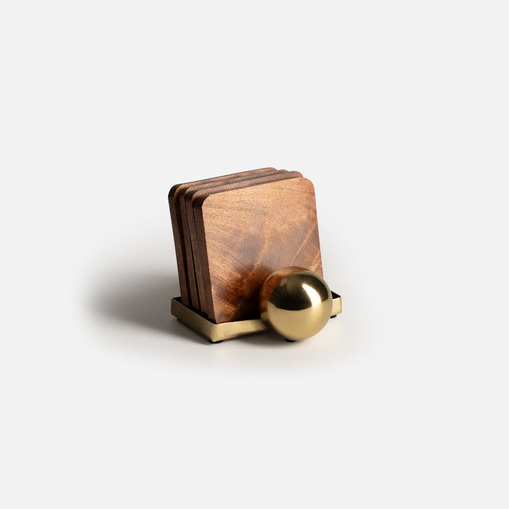 Wooden coasters with a gold holder on a white background
