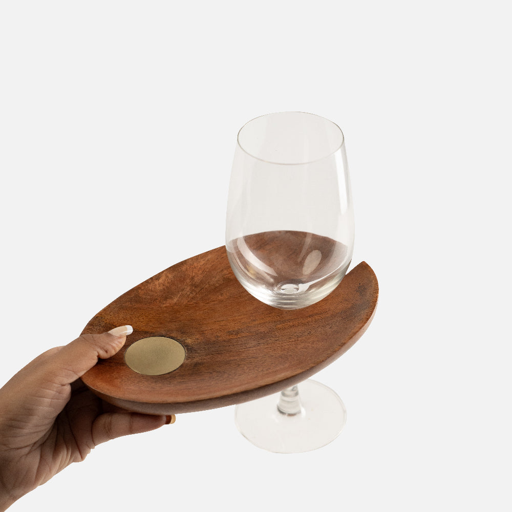 Wooden tray with a round coaster holding a wine glass on a white background