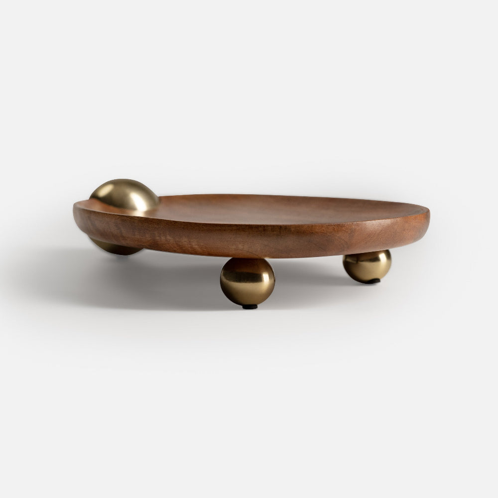 Wooden tray with gold spherical feet on a white background