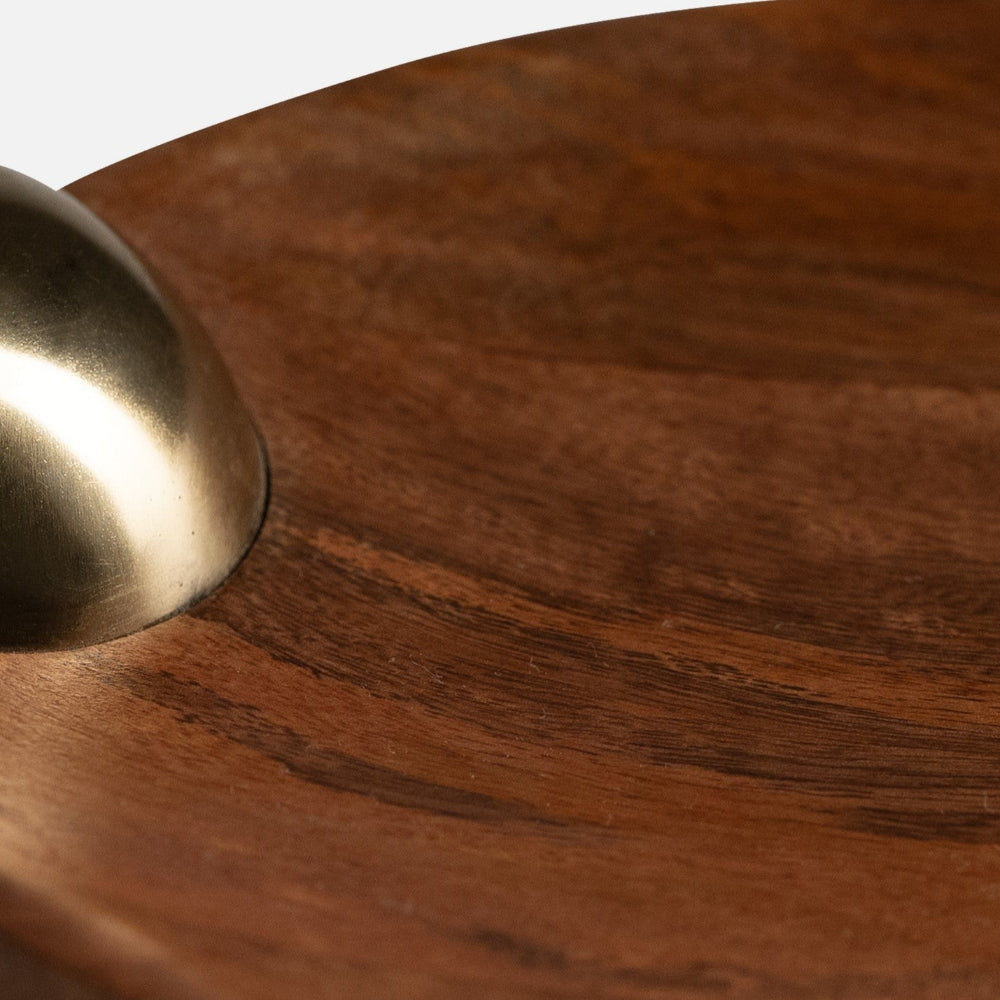 Close-up of a wooden surface with a brass knob