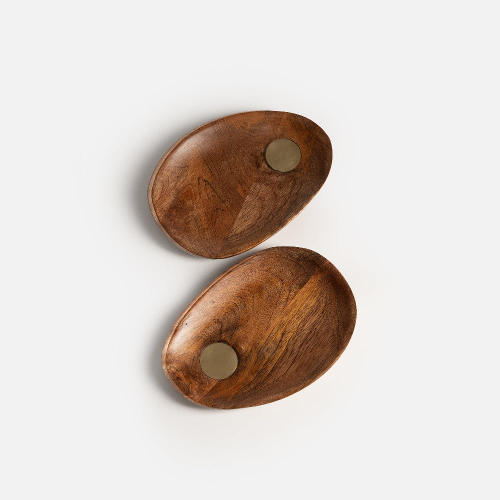 Two wooden coasters with metal studs on a white background