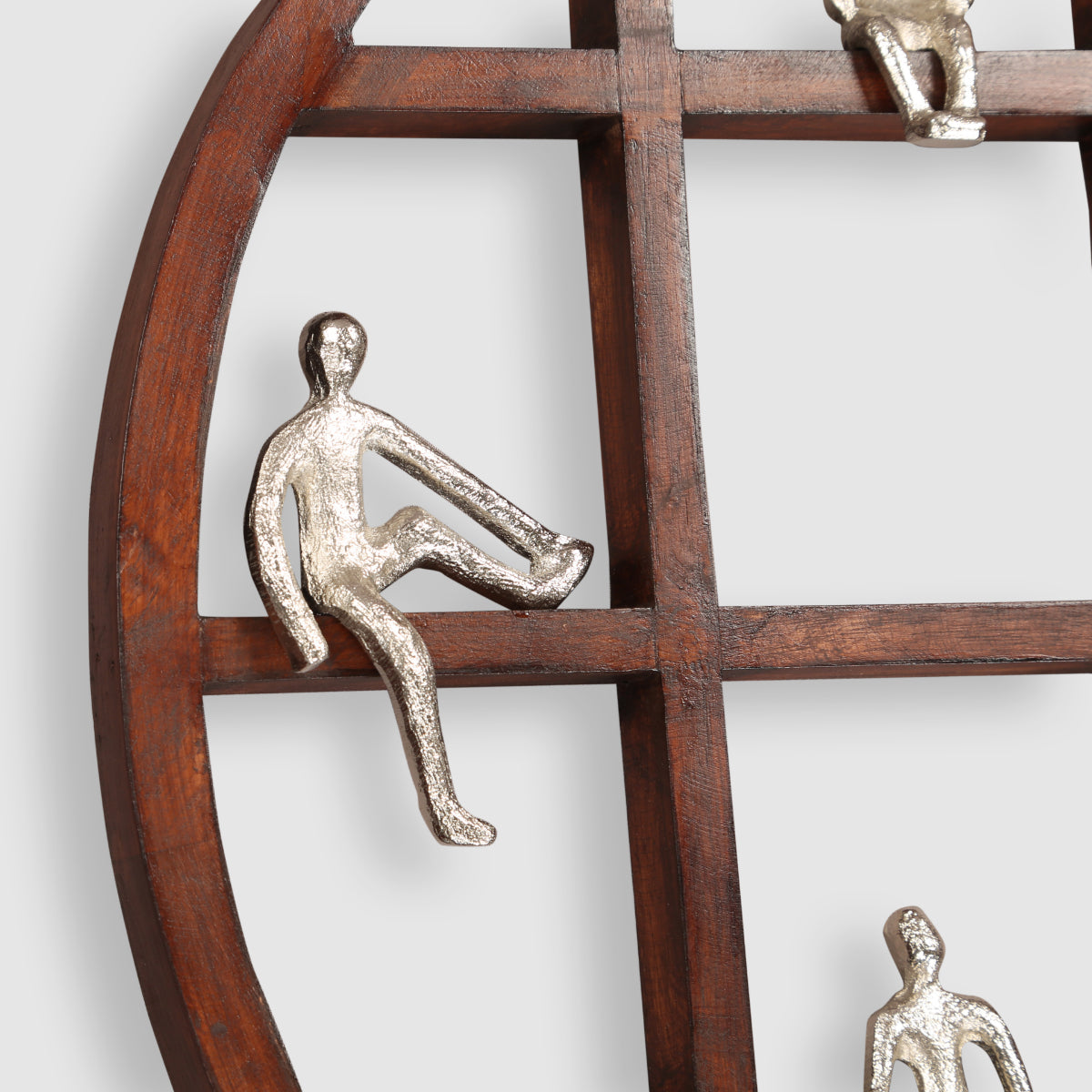 Decorative wall piece with wooden structure and metallic figures on a white background