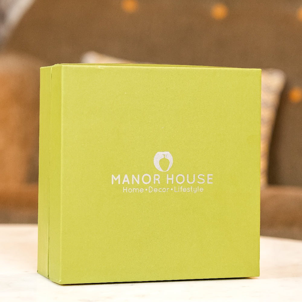 Green box with 'Manor House' branding on a blurred background