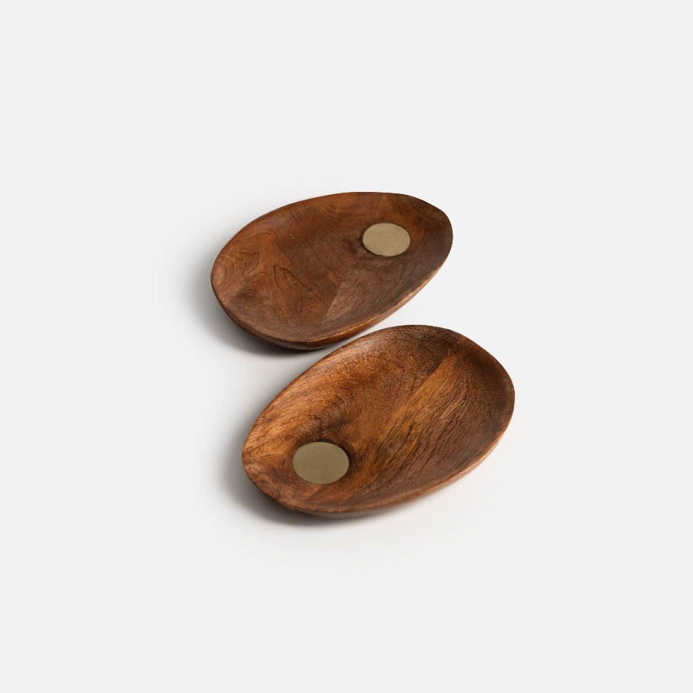 Two wooden coasters with metal magnets on a white background