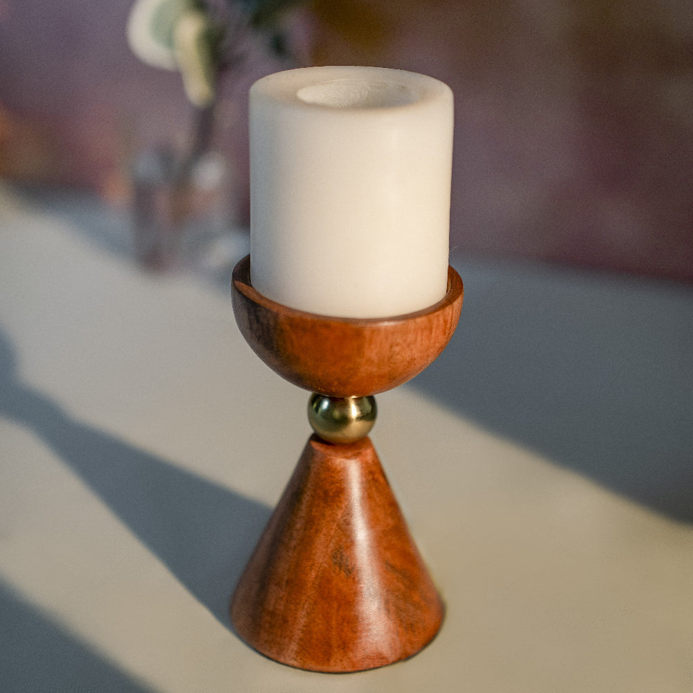 Wooden candle holder with a white candle on a blurred background