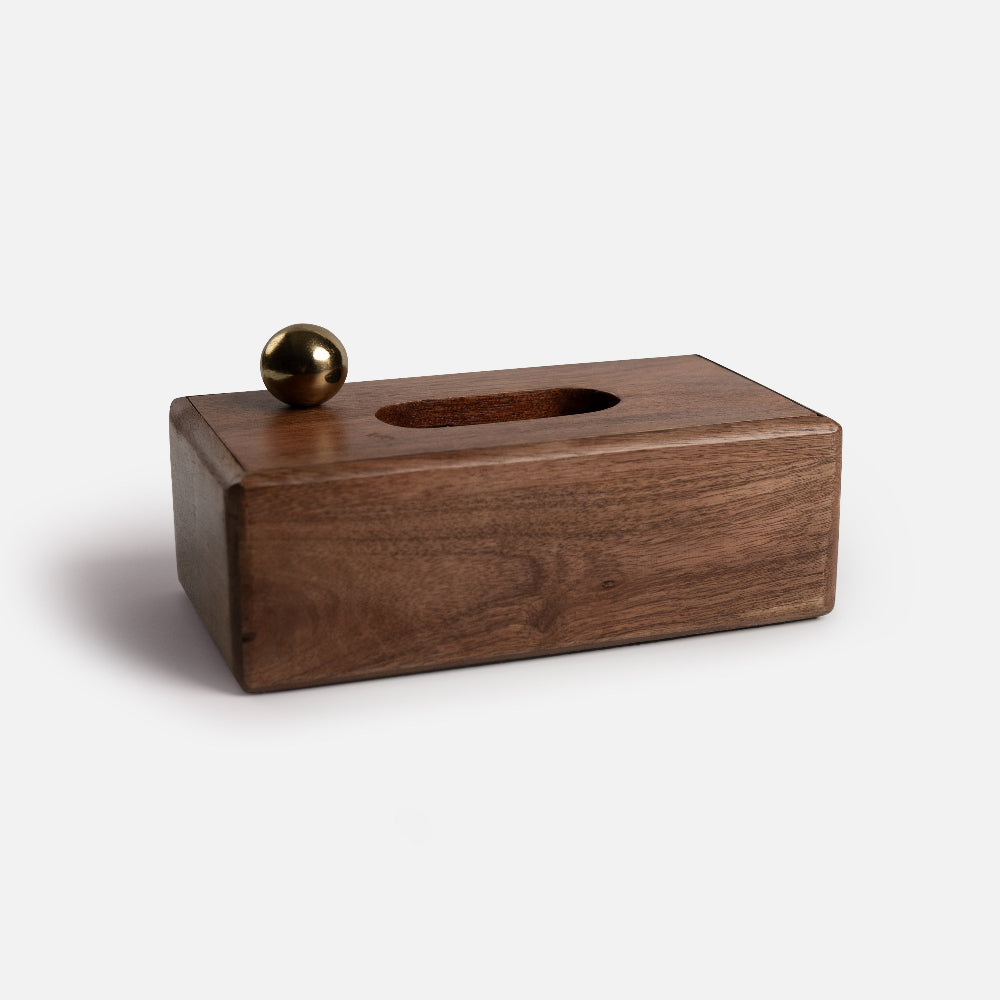 Wooden block with a spherical metal object on a white background