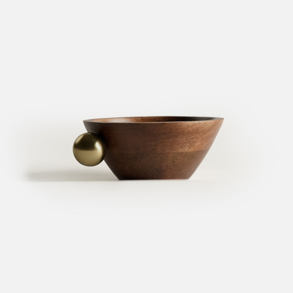 Wooden bowl with a gold sphere on a white background